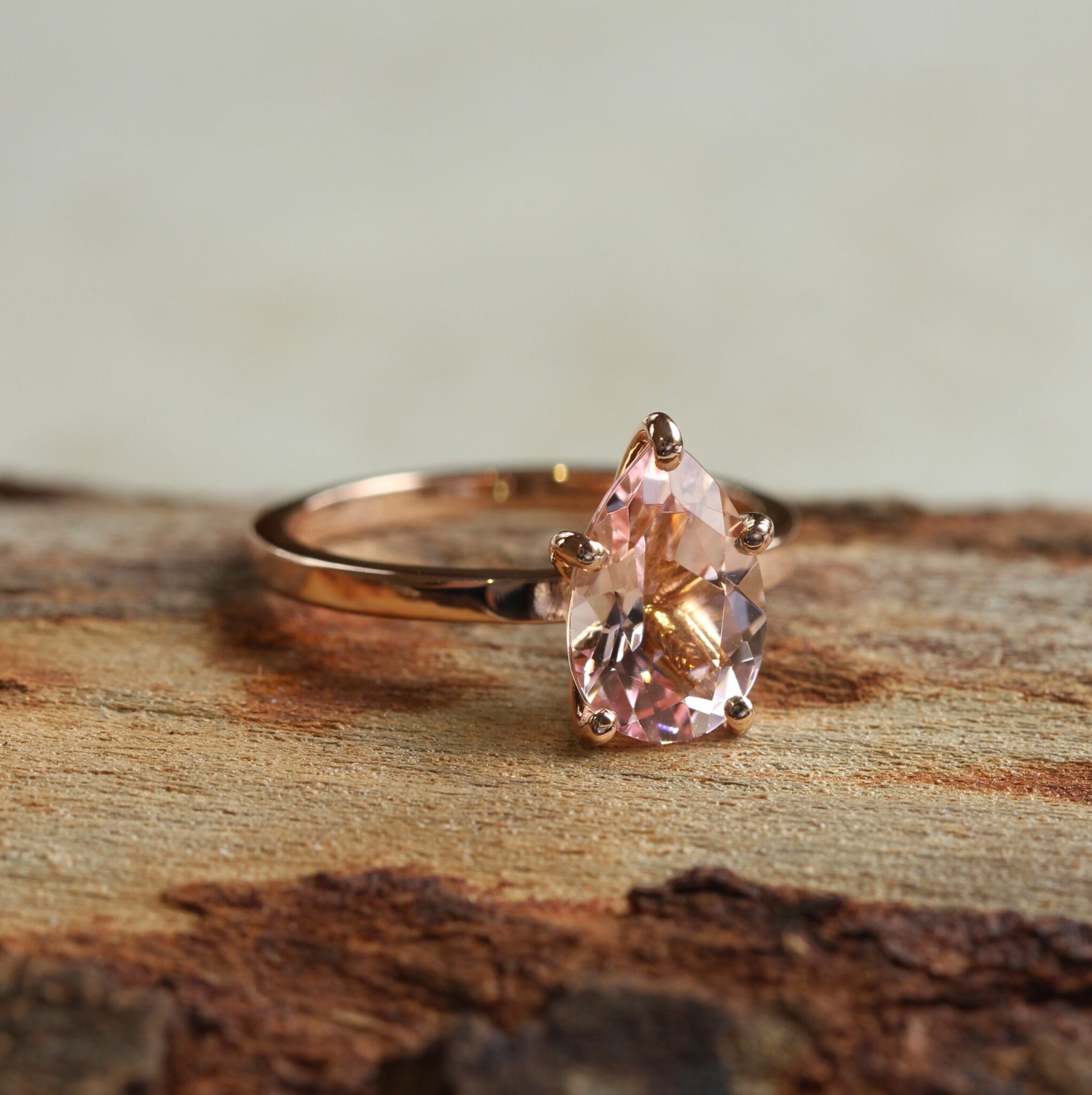 true-pink-morganite-solitaire-engagement-ring-12x8mm-pear-cut-six-prongs-14k-rose-gold-LS5951-front-wood