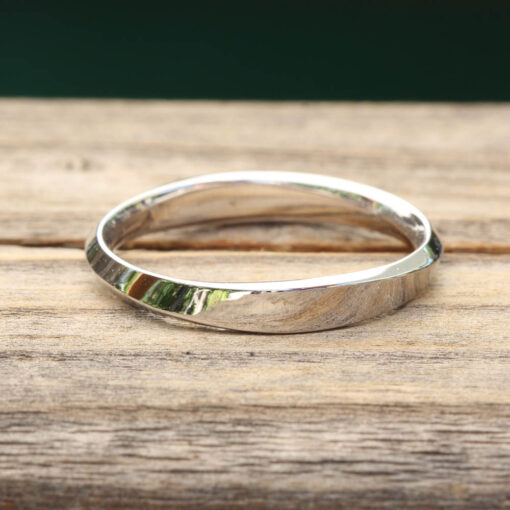 This Mobius Wedding Band is part of our Clarice Collection, which is our collection featuring Classic pieces that make the perfect gifts! Other designs, widths and finishes available upon request!